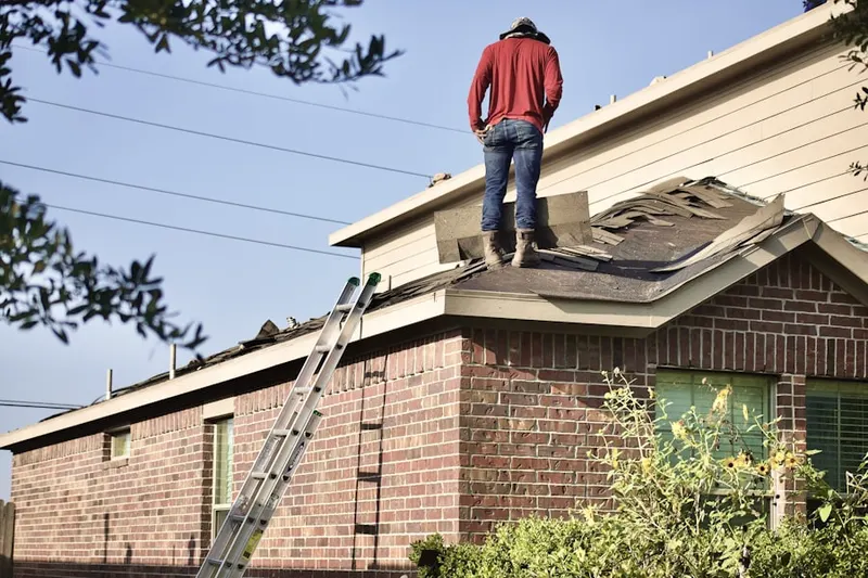 Professional roofer working on a residential roof in Ukrainian Village